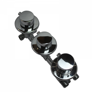 A high-resolution studio image of a 3 dial thermostatic shower mixer valve photographed at an angle against a black background. The valve is shown fully assembled with three chrome control dials mounted on circular backplates, connected by a rigid metal manifold. The polished chrome finish reflects light clearly, highlighting the smooth surfaces of the controls and indicating how the valve appears once installed behind a shower cabin control panel as a replacement unit.