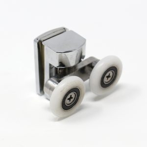 A close-up view of a top-mounted, height-adjustable Insignia shower door roller assembly, specifically designed for Insignia shower cabins and steam enclosures. The unit features a durable zinc alloy body with a polished chrome-style finish, giving it a shiny, reflective appearance. Attached to the main housing is a sturdy metal carrier supporting twin white nylon wheels, positioned side-by-side to distribute weight evenly. The wheels, which measure 24mm in diameter, feature visible central screws and internal bearings, ensuring smooth and quiet operation along the upper rail. The mechanism includes an adjustment feature within the metal body to fine-tune the vertical position of the glass door. Displayed against a clean white background, this replacement part highlights the robust construction required for moisture-rich environments like hydromassage showers and sliding door cubicles.